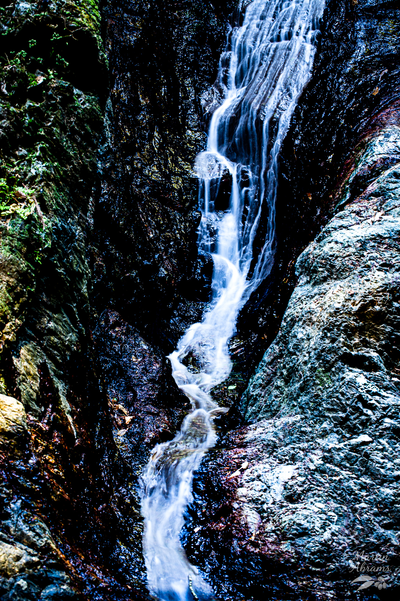 Waterfall in dark rocks