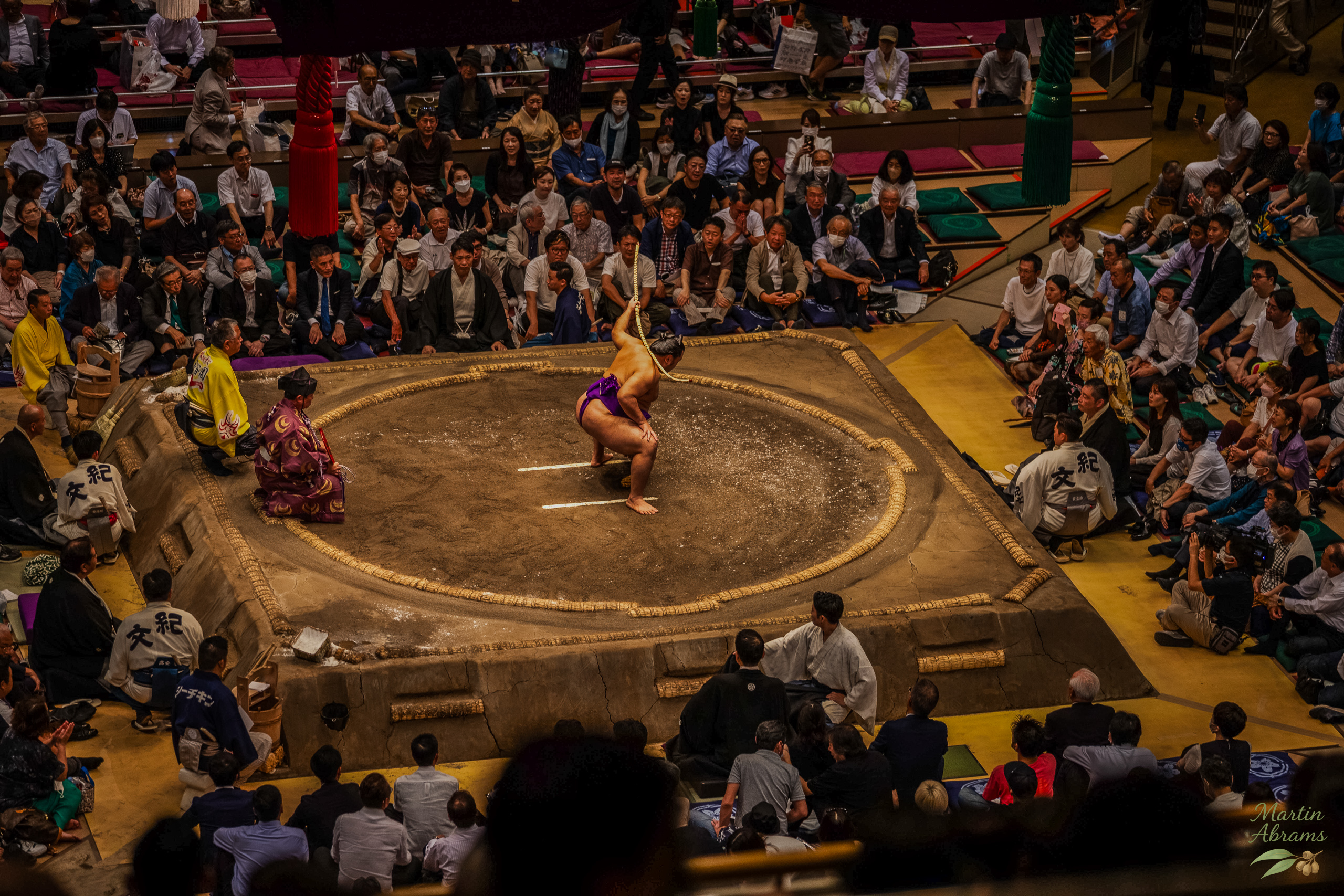 Sumo - champion squats with staff overhead